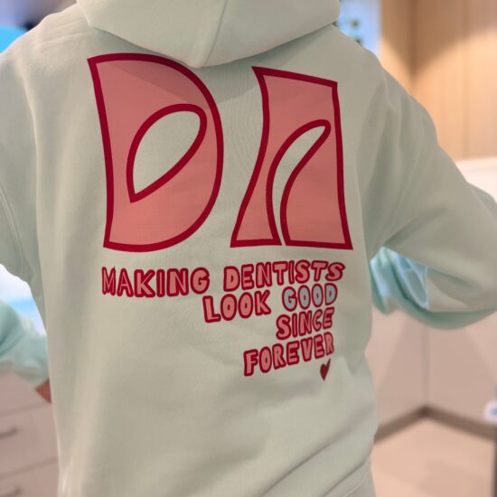 Dental assistant hoodie in seafoam, back print reading Making Dentists Look Good Since Forever
